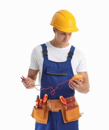 Electrician with multimeter wearing uniform on white background