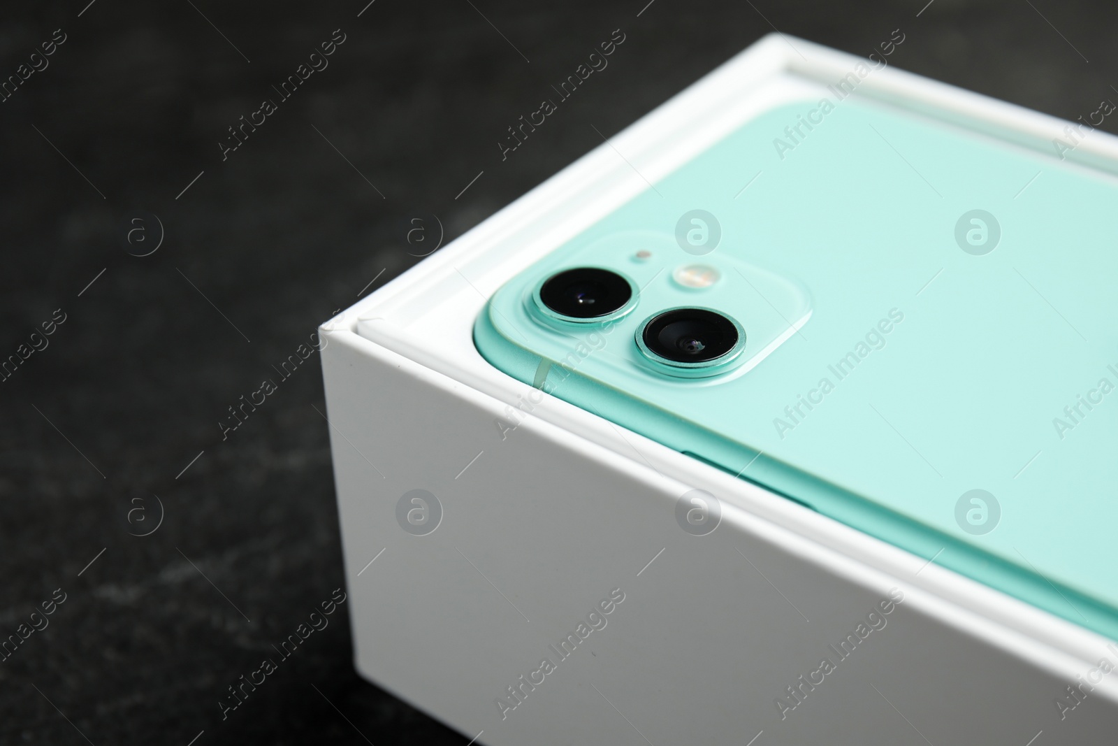 Photo of MYKOLAIV, UKRAINE - JULY 10, 2020: New modern Iphone 11 Green in original box on grey table, closeup