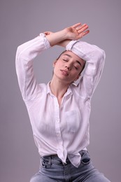 Photo of Portrait of beautiful young woman posing on light grey background