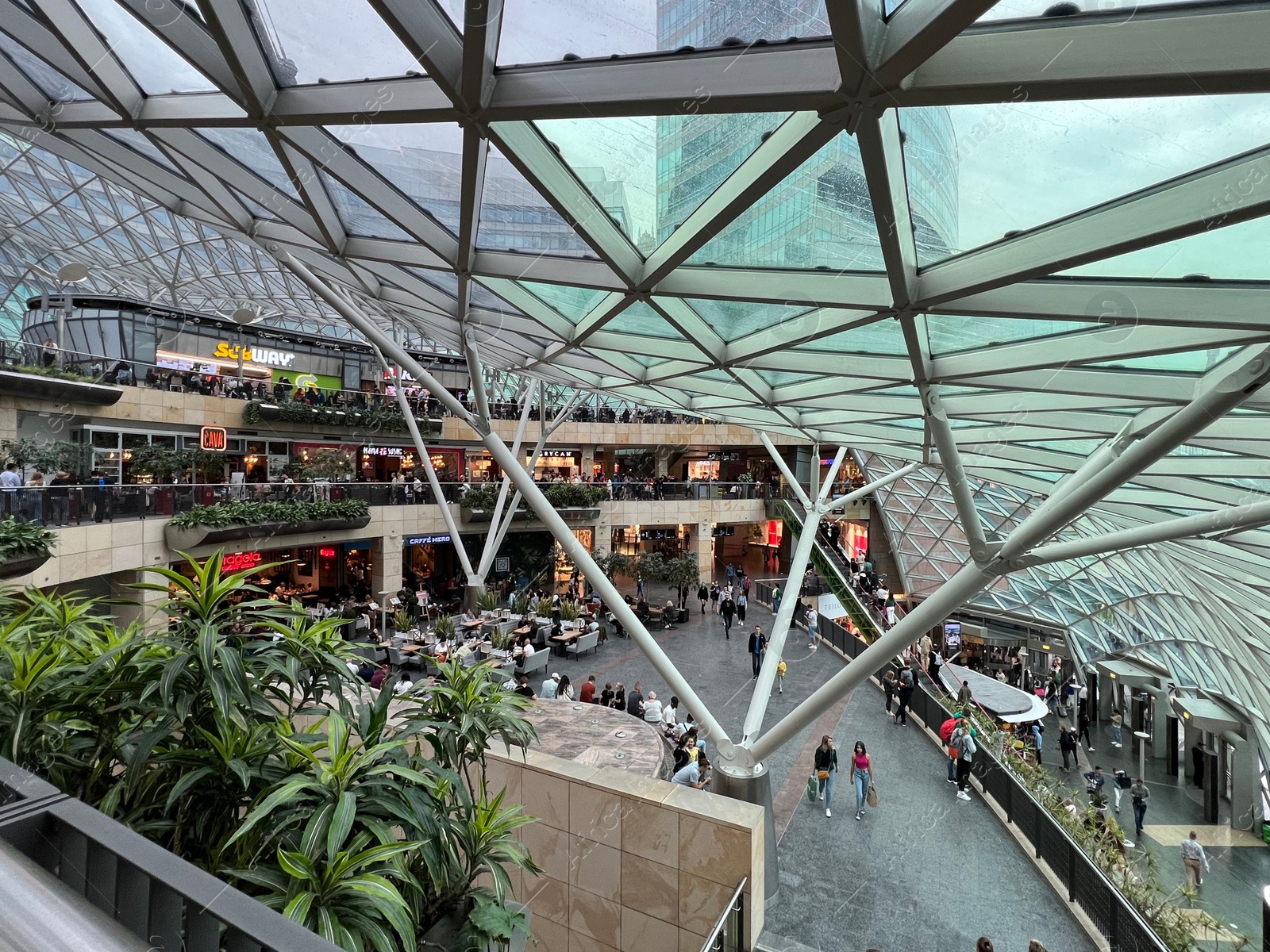 Photo of WARSAW, POLAND - JULY 17, 2022: Big shopping mall with many stores and customers