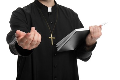 Photo of Priest with Bible praying on white background, closeup