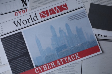 Photo of Top view of newspapers with headlines CYBER ATTACK as background