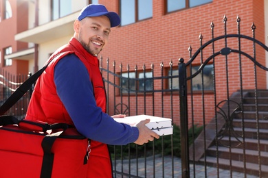 Photo of Male courier delivering food in city on sunny day