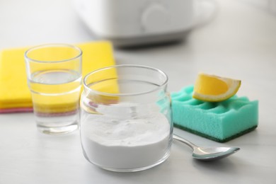 Baking soda, lemon and vinegar on light stone table. Eco friendly detergents