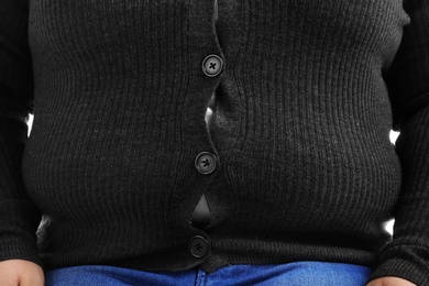 Photo of Overweight person in tight clothes, closeup