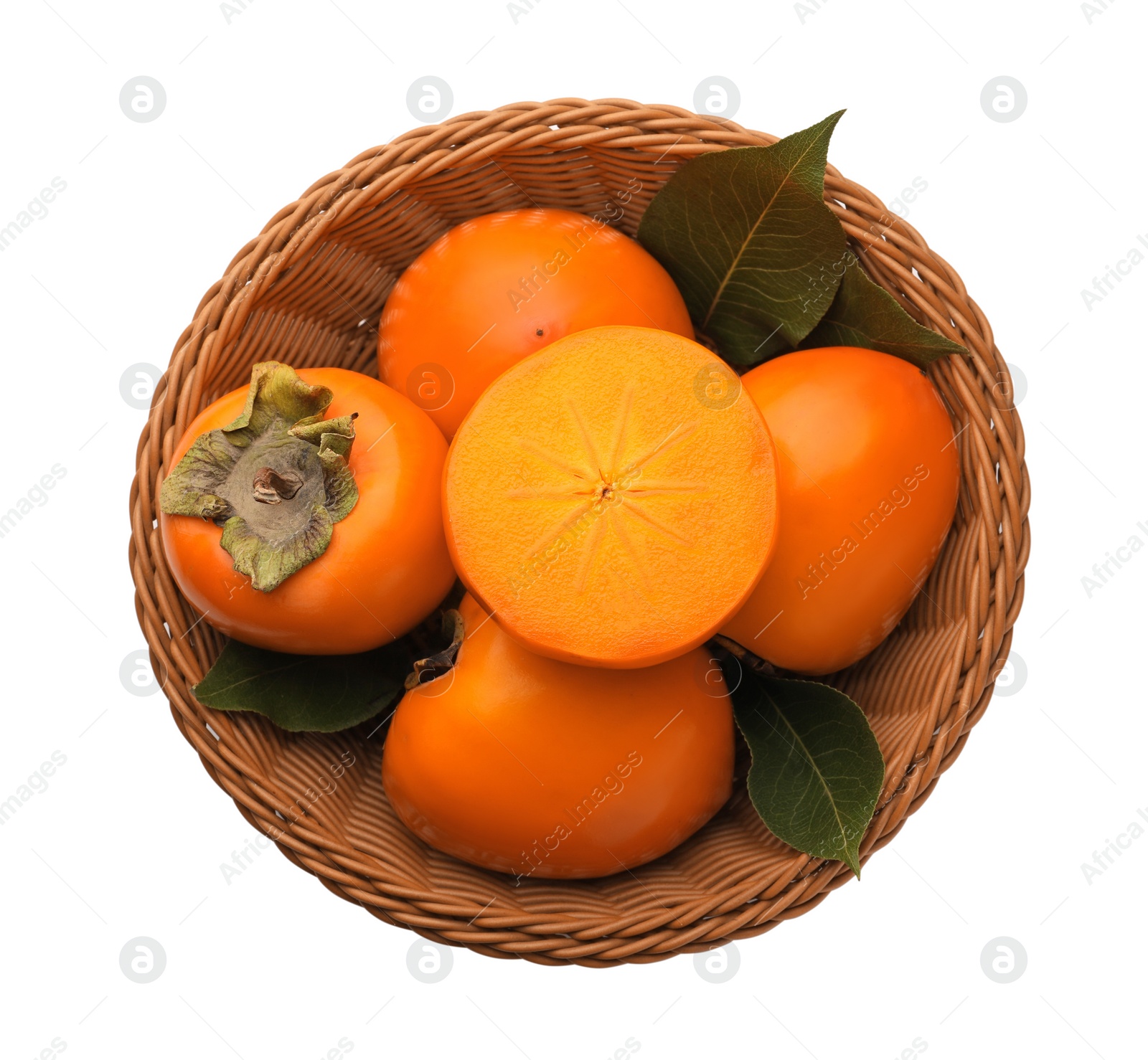 Photo of Delicious ripe persimmons in wicker basket on white background, top view