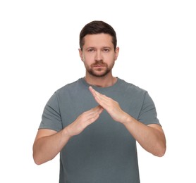 Photo of Handsome man showing time out gesture isolated on white. Stop signal