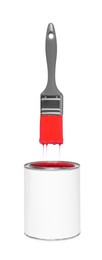 Image of Brush with red paint in air over can on white background