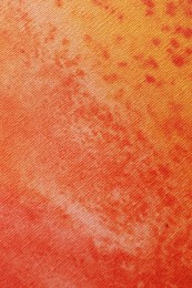 Photo of Orange fabric with pattern as background, top view