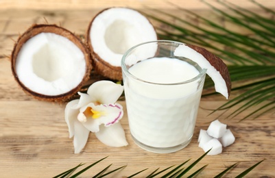 Photo of Glass of coconut milk on wooden background