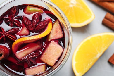 Flat lay composition with glass of hot mulled wine on gray background