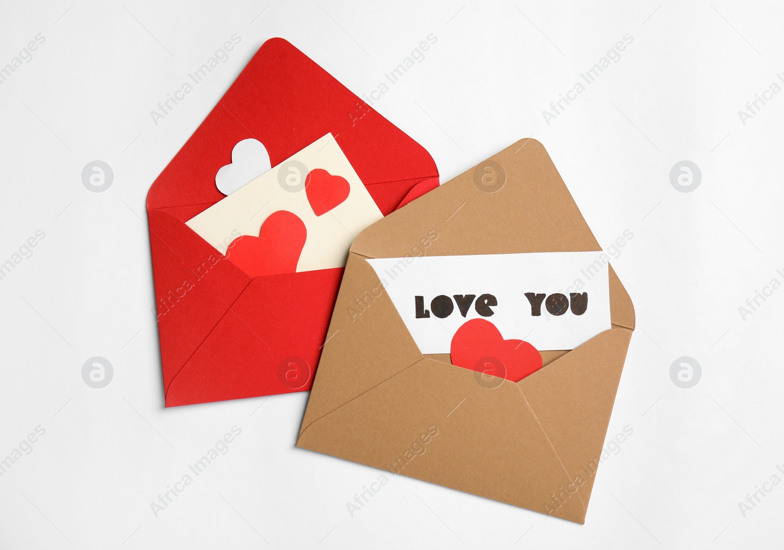 Photo of Card with phrase Love You, envelopes and paper hearts on white background, flat lay