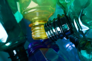 Photo of Used plastic bottles as background, closeup. Recycling problem