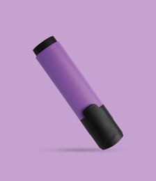 One marker (highlighter) with cap on violet background
