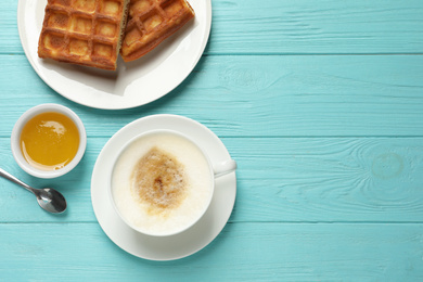 Photo of Tasty breakfast served on light blue wooden table, flat lay. Space for text