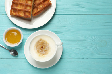 Tasty breakfast served on light blue wooden table, flat lay. Space for text