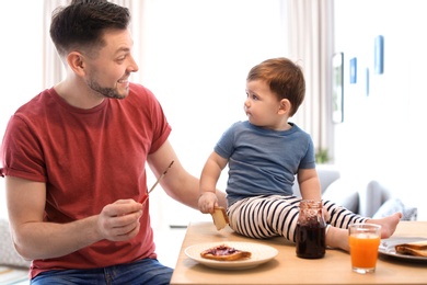 Dad and his son having breakfast in kitchen