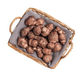 Photo of Wicker basket with many Jerusalem artichokes isolated on white, top view