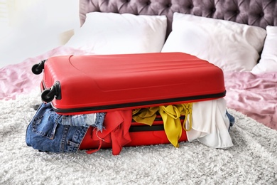 Photo of Packed travel suitcase on bed