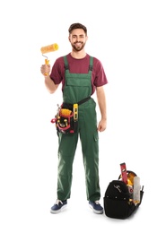 Full length portrait of professional construction worker with tools on white background