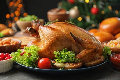 Photo of Traditional festive dinner with delicious roasted turkey served on table