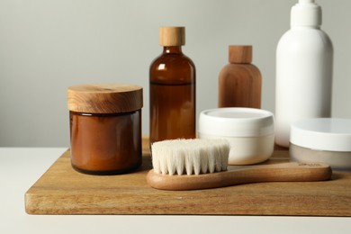 Different bath accessories on white table against grey background, closeup