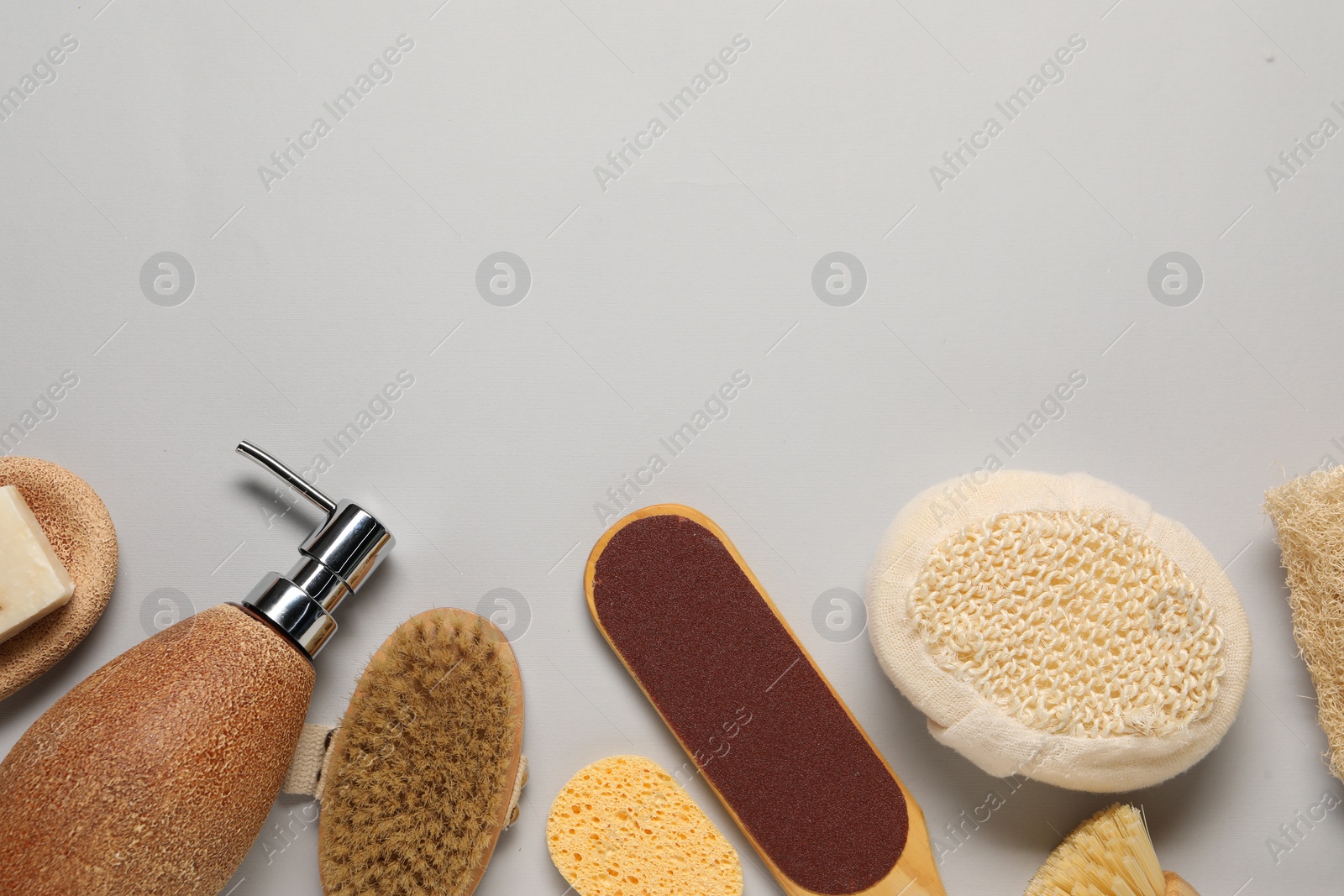 Photo of Bath accessories. Flat lay composition with personal care tools on light grey background, space for text