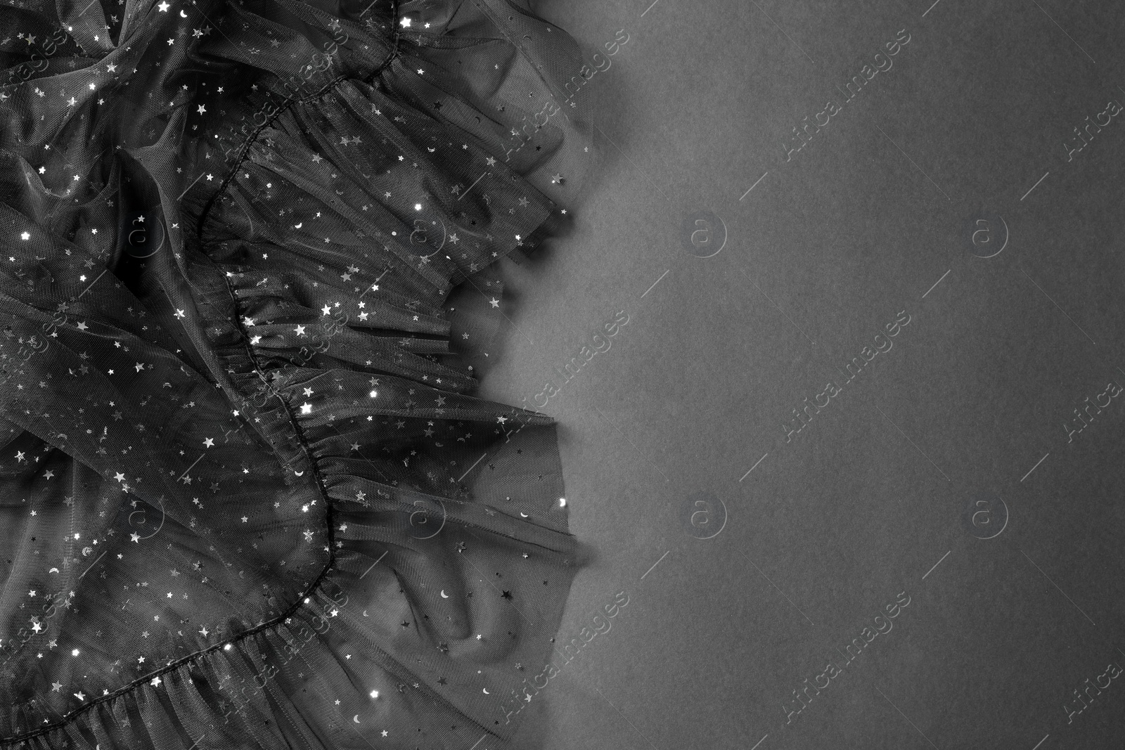 Photo of Beautiful black tulle fabric on grey background, top view. Space for text