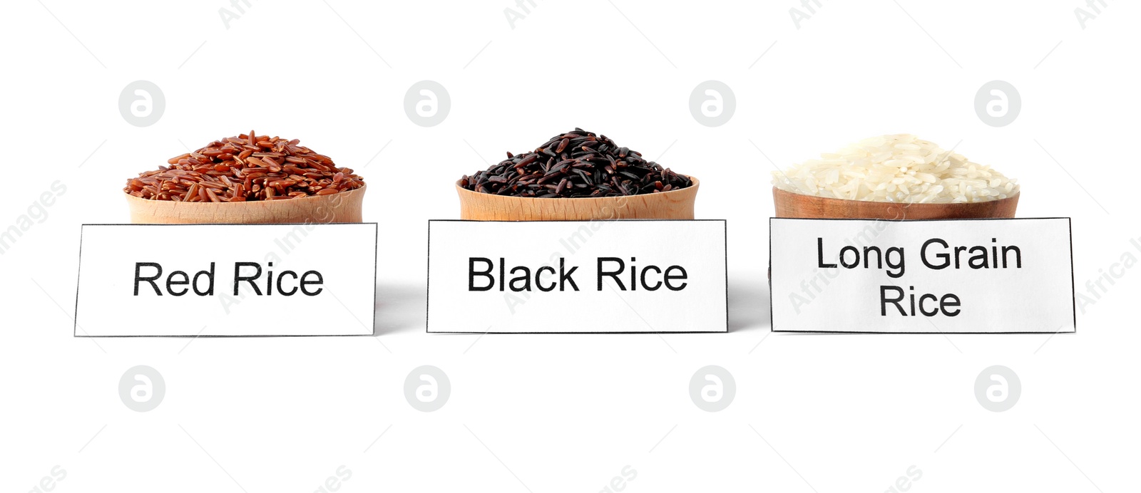 Photo of Bowls with different types of uncooked rice and cards on white background