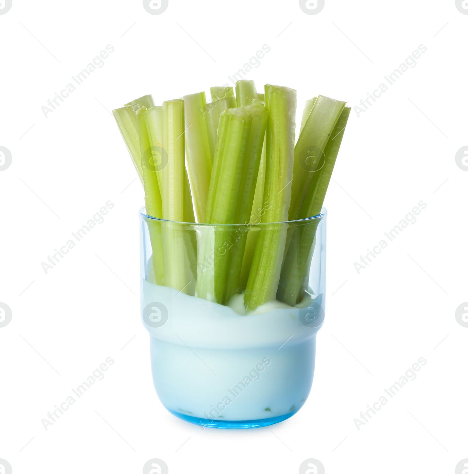 Photo of Celery sticks with dip sauce in glass isolated on white
