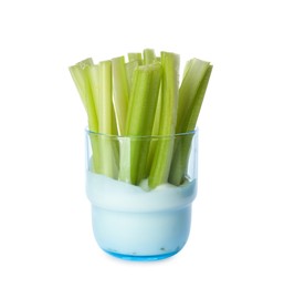 Celery sticks with dip sauce in glass isolated on white