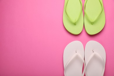 Photo of Stylish white and light green flip flops on pink background, flat lay. Space for text