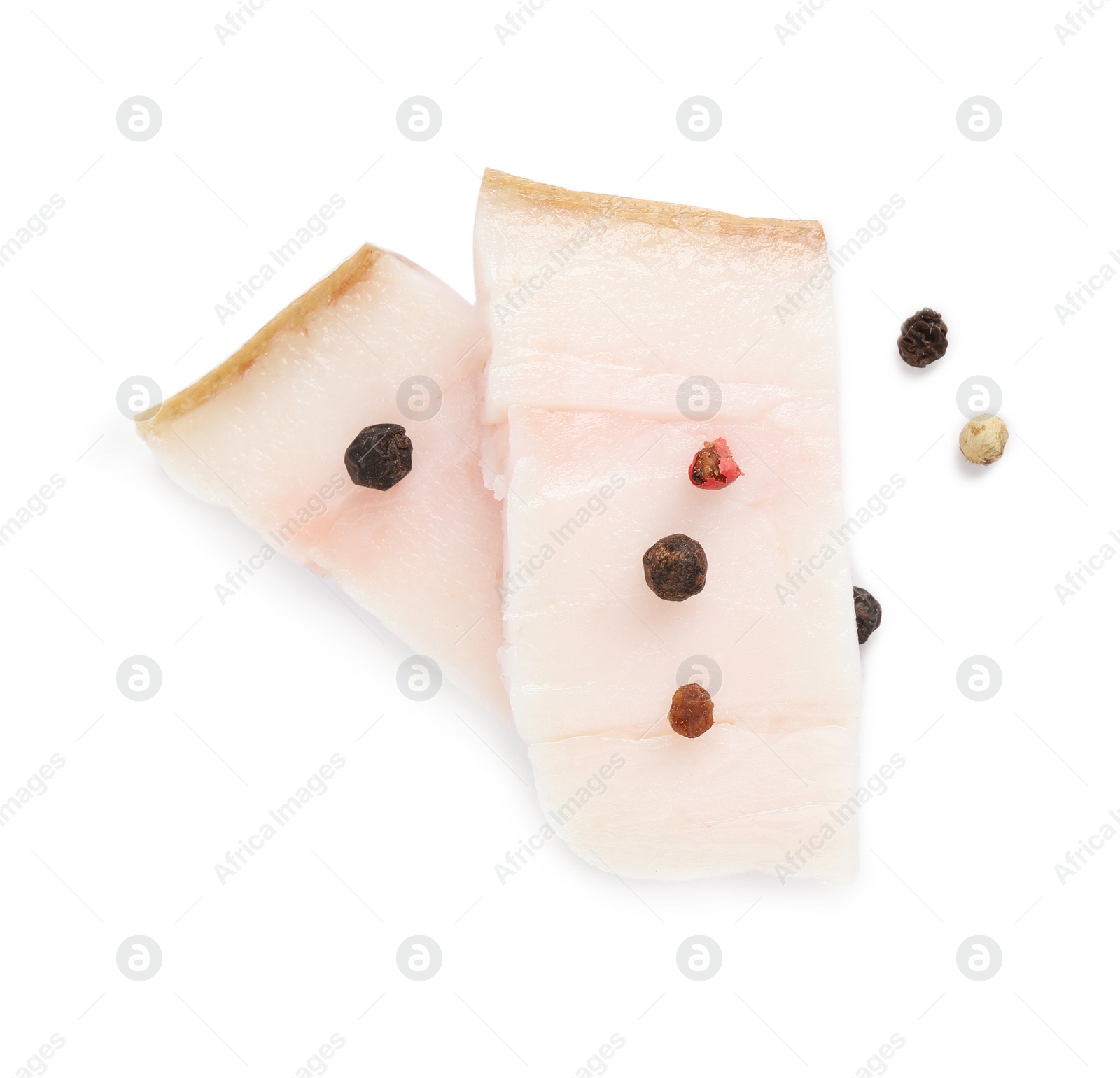 Photo of Slices of pork fatback with pepper isolated on white, top view