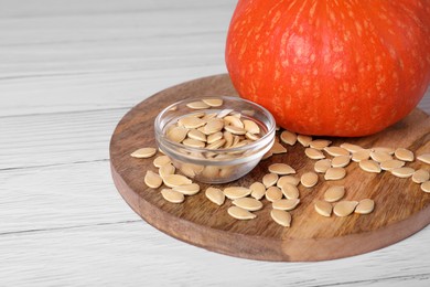 Photo of Fresh pumpkin and vegetable seeds on white wooden table, closeup