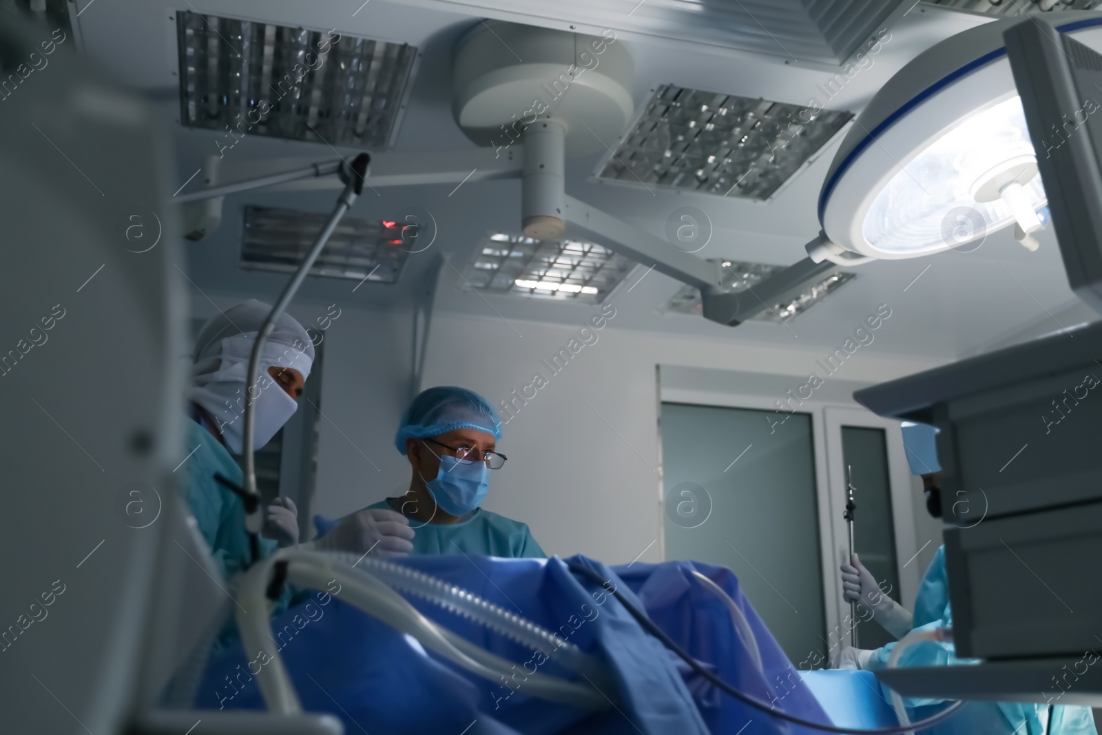 Photo of Medical team performing surgery in operating room