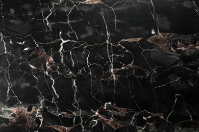 Texture of black marble stone surface as background, closeup