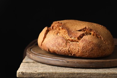 Photo of Freshly baked sourdough bread on wooden table