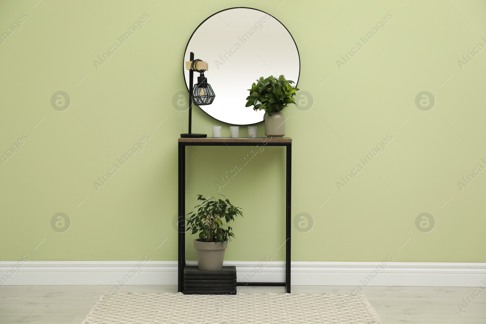 Photo of Hallway with stylish console table and mirror. Interior design