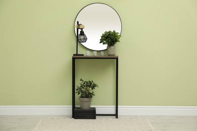 Hallway with stylish console table and mirror. Interior design