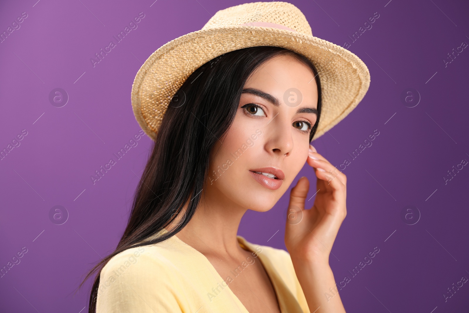 Photo of Portrait of beautiful young woman on purple background