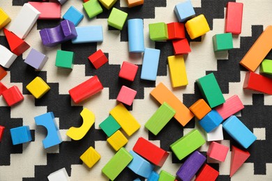 Photo of Colorful wooden building blocks on carpet, flat lay