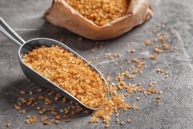 Scoop with brown sugar on table