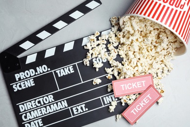 Photo of Flat lay composition with popcorn and cinema tickets on grey background