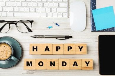 Photo of Flat lay composition with phrase Happy Monday made of cubes at workplace