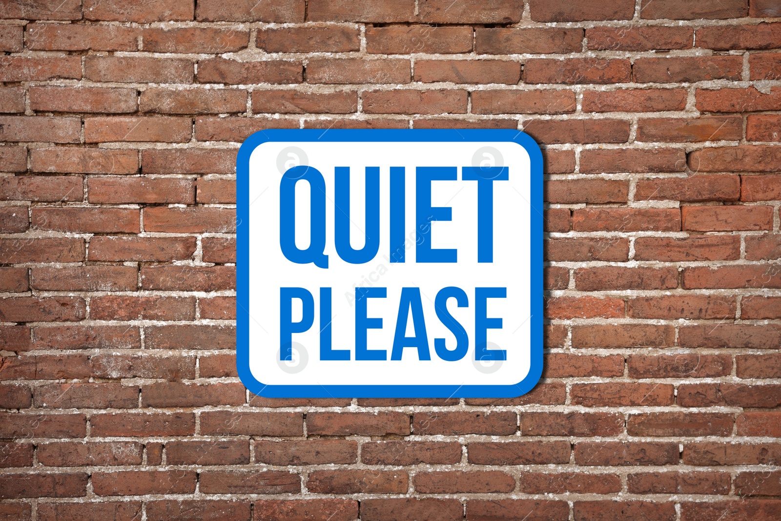 Image of Quiet Please sign on red brick wall