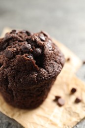 Photo of Delicious fresh chocolate muffin on table, closeup