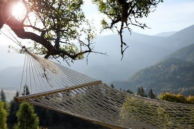 Comfortable net hammock in mountains on sunny day, closeup