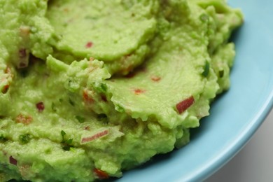 Photo of Bowl with delicious fresh guacamole, closeup view