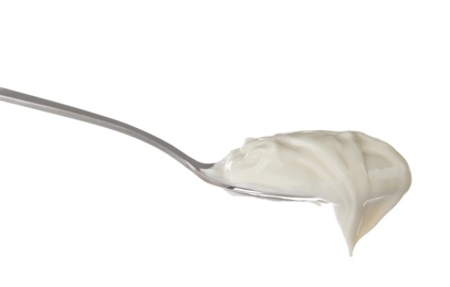 Metal spoon with sour cream on white background