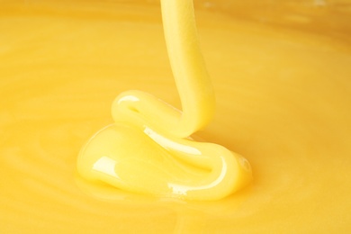 Photo of Pouring fresh sweet honey, closeup